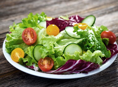 Teller mit Salat, Tomaten und Gurkenscheiben
